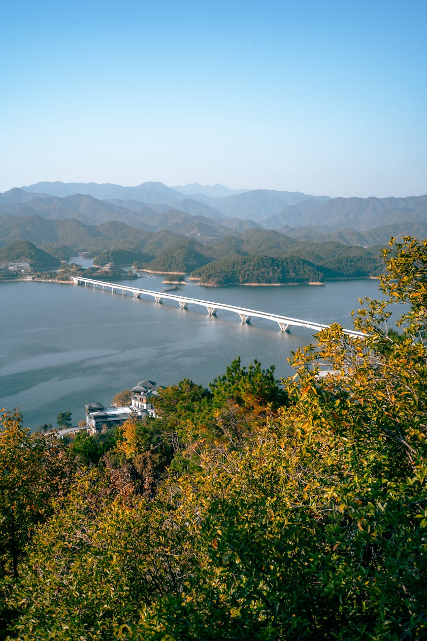 Photo by Cheng Shi Song | via Pexels | License: Pexels License | https://www.pexels.com/photo/stunning-aerial-view-of-qiandao-lake-bridge-in-autumn-34923107/