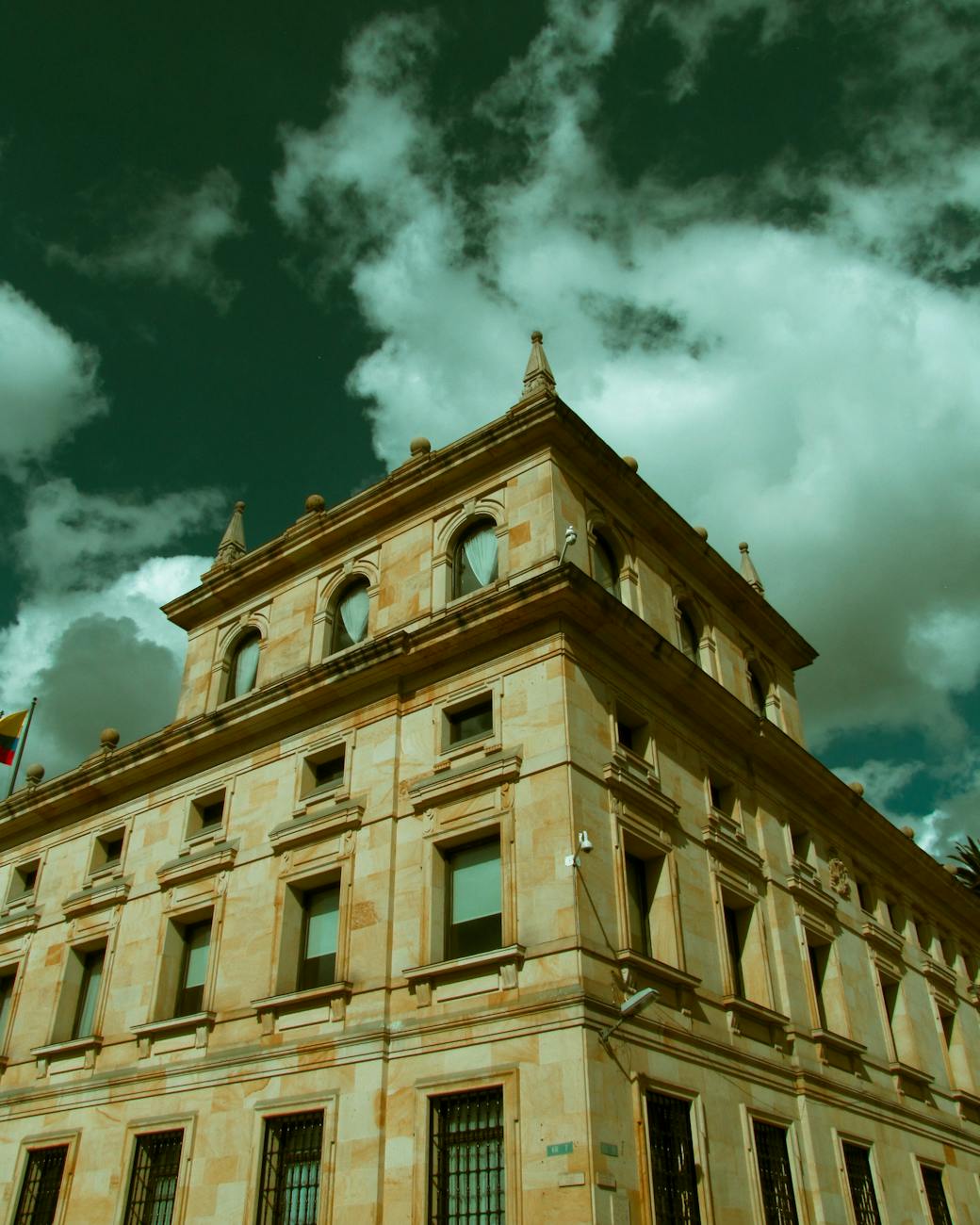 Photo by Paula  Riaño | via Pexels | License: Pexels License | https://www.pexels.com/photo/a-low-angle-shot-of-a-concrete-building-under-the-cloudy-sky-13589990/