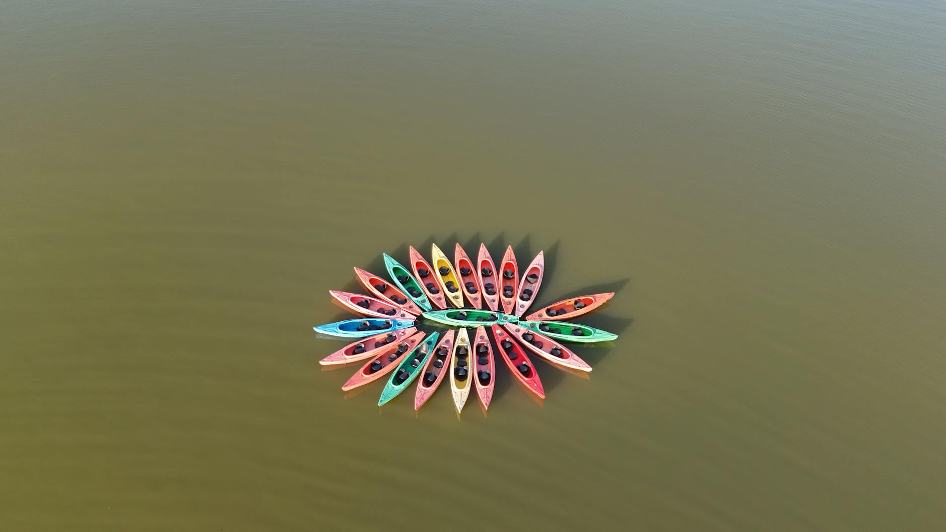 Photo by CHINA YU | via Pexels | License: Pexels License | https://www.pexels.com/photo/aerial-view-of-colorful-kayaks-arranged-in-circle-formation-35422097/