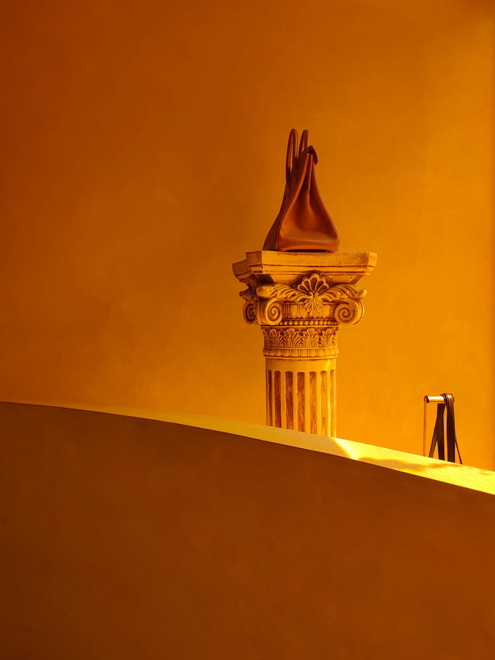 Photo by 浩东 陈 | via Pexels | License: Pexels License | https://www.pexels.com/photo/brown-handbag-standing-on-column-abacus-in-yellow-room-19136074/