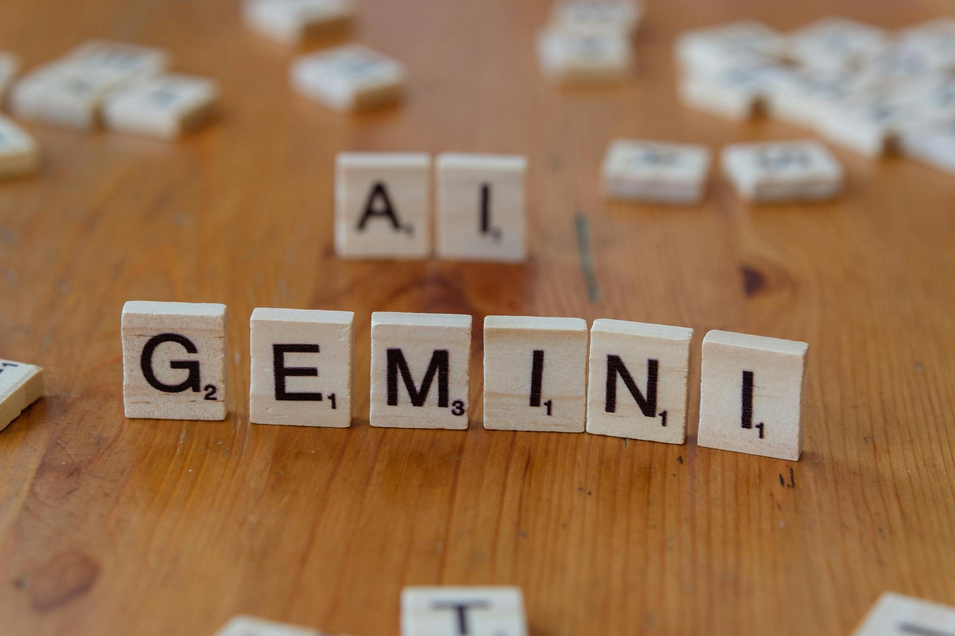 Photo by Markus Winkler | via Pexels | License: Pexels License | https://www.pexels.com/photo/scrabble-tiles-spelling-gemini-and-ai-on-wooden-surface-30869085/