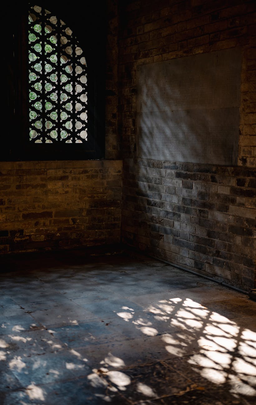 Photo by Cheng Shi Song | via Pexels | License: Pexels License | https://www.pexels.com/photo/sunlight-streams-through-historic-window-grille-33792330/