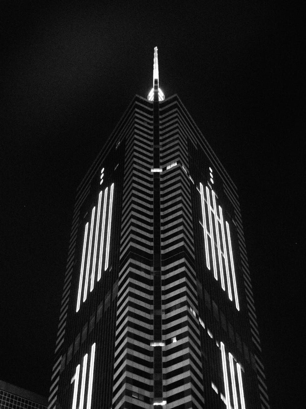 Photo by terry narcissan tsui | via Pexels | License: Pexels License | https://www.pexels.com/photo/nighttime-view-of-iconic-hong-kong-skyscraper-35622383/