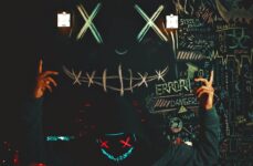 Photo by Lucas Andrade | via Pexels | License: Pexels License | https://www.pexels.com/photo/anonymous-man-in-a-hood-holding-a-sign-14032880/